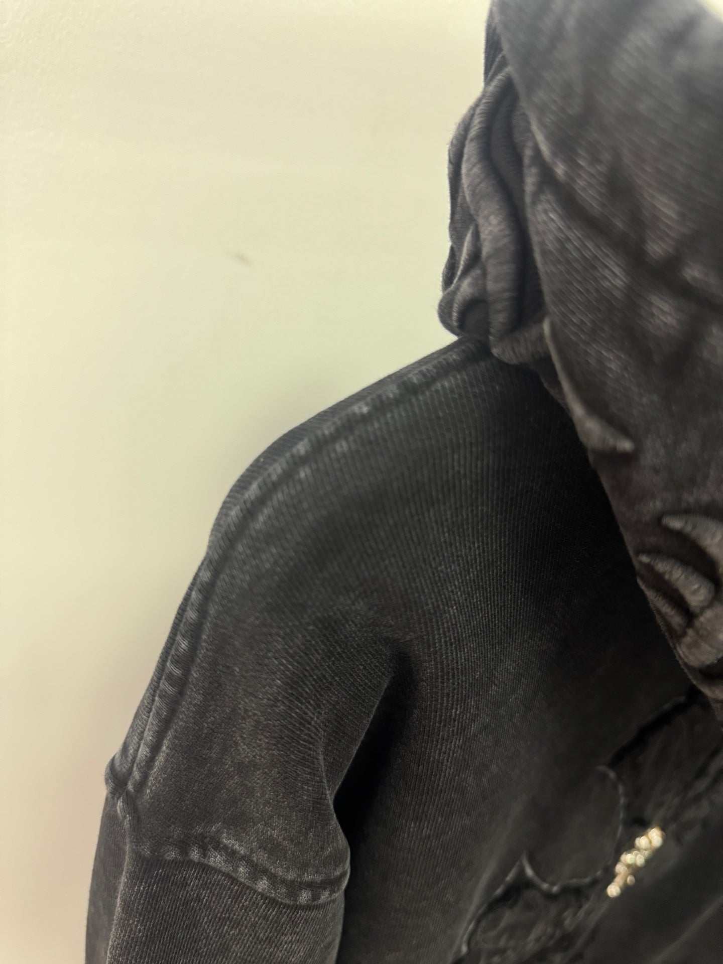 Dark long-sleeve hooded top with textured fabric