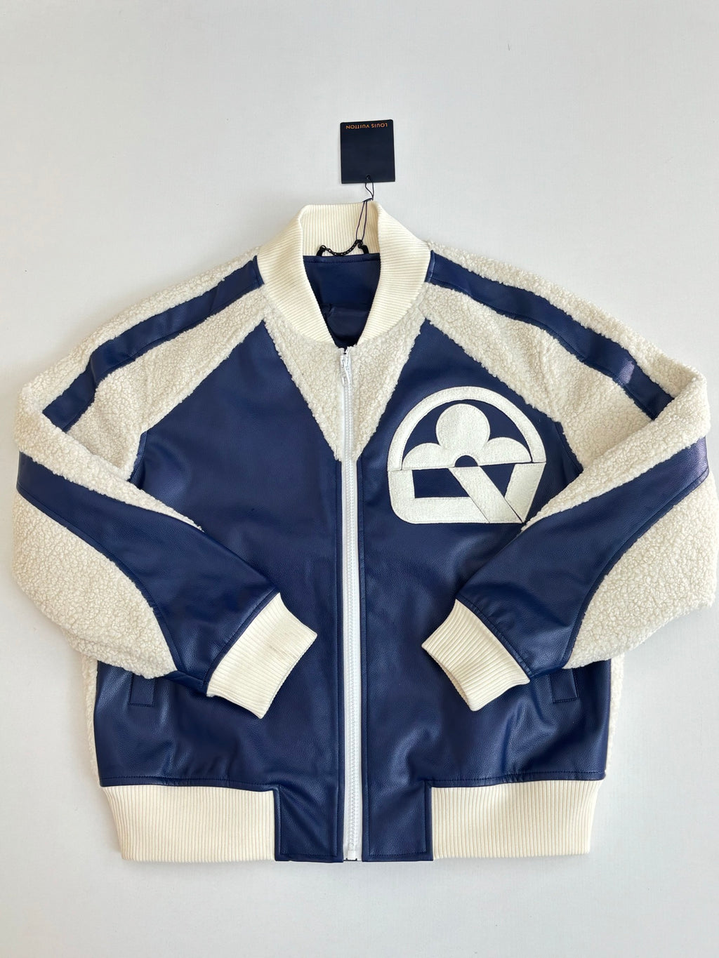 Colorblock zip-up jacket with sherpa collar and cream side stripes on navy