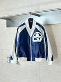 Colorblock sherpa-trim jacket with front zip and large cream logo on navy