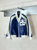 Colorblock sherpa-trim jacket with front zip and large cream logo on navy