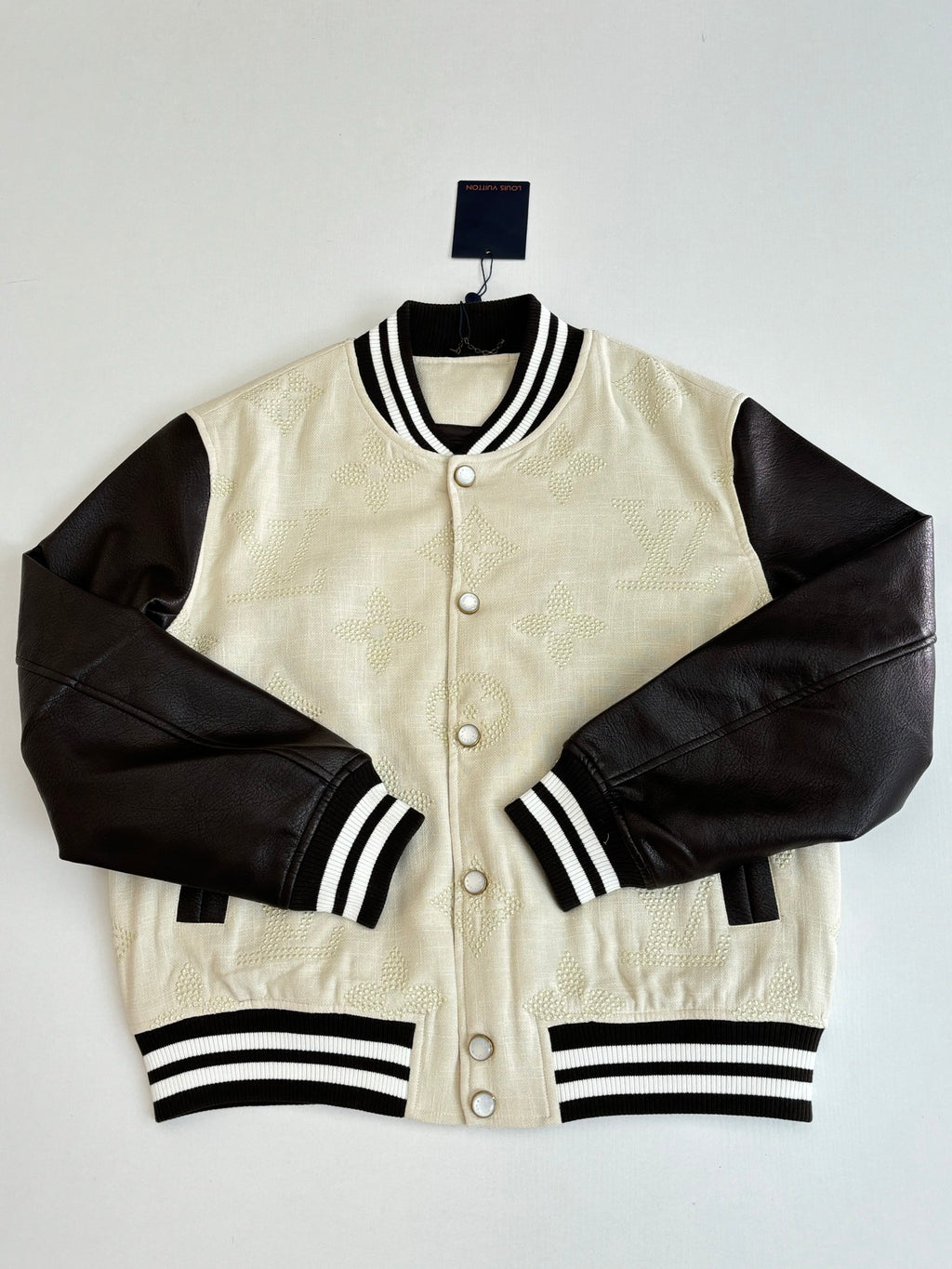 Louis Vuitton varsity jacket, cream textured body, black sleeves, button front, striped ribbing