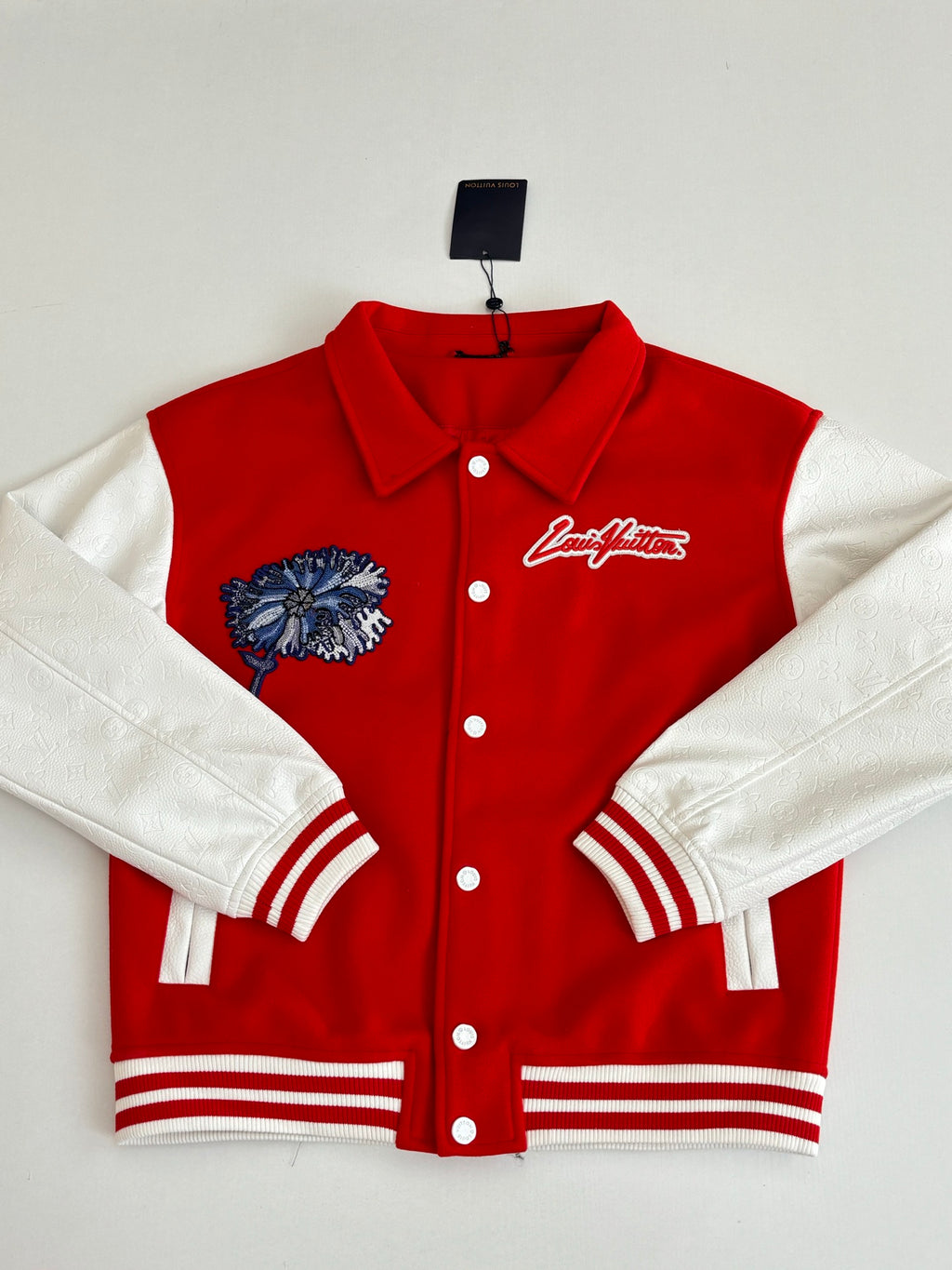Red varsity jacket with white sleeves, button front, and Louis Vuitton script chest logo