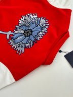 Long-sleeve top with red body and blue-gray embroidered snowflake applique