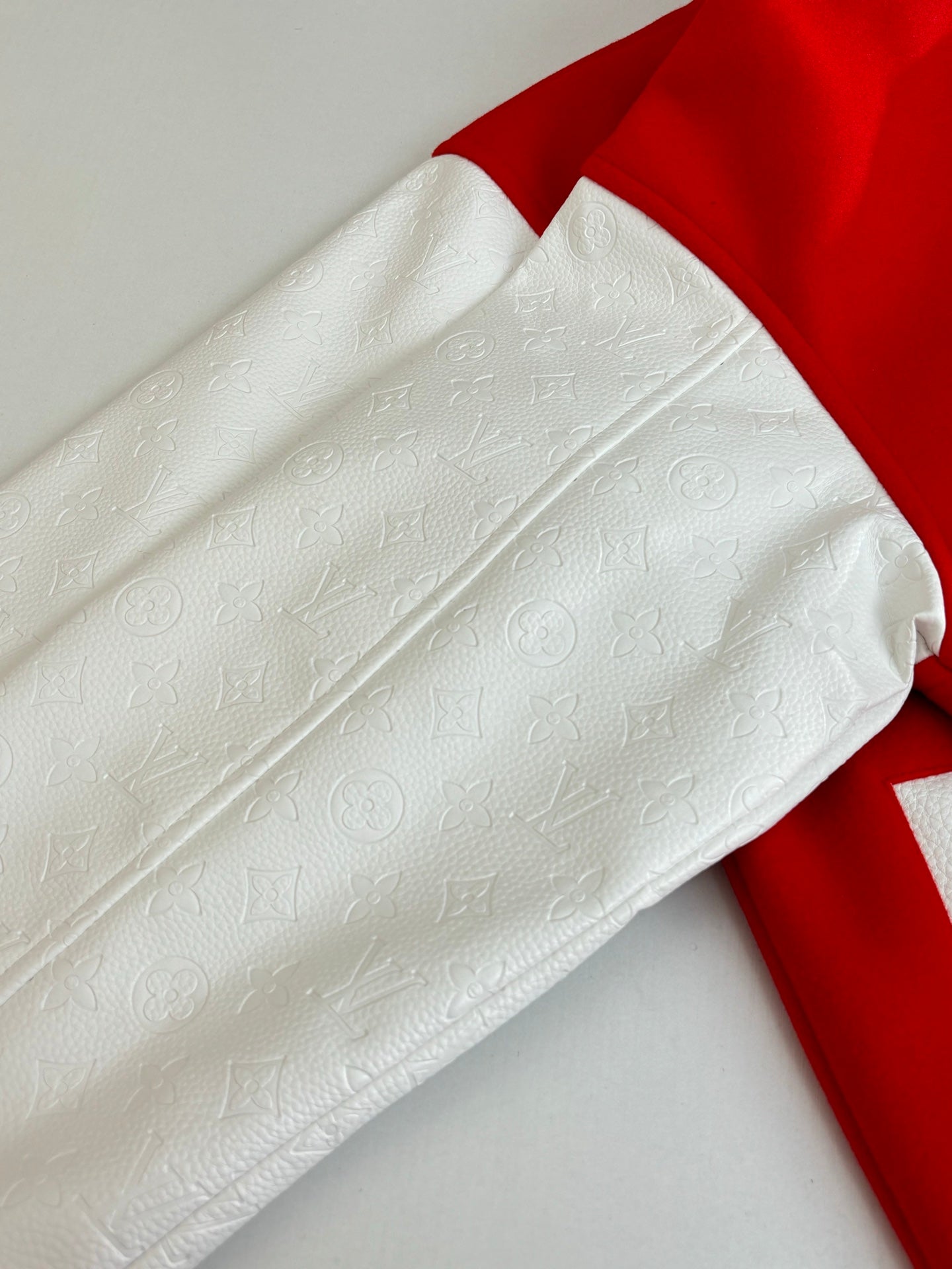 Louis Vuitton long-sleeve top, white embossed fabric with red sleeve