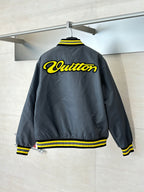 Louis Vuitton bomber jacket, dark gray back view with yellow logo and striped hem