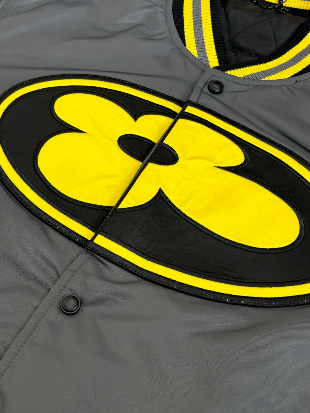 Louis Vuitton bomber jacket logo patch in yellow on dark gray front panel