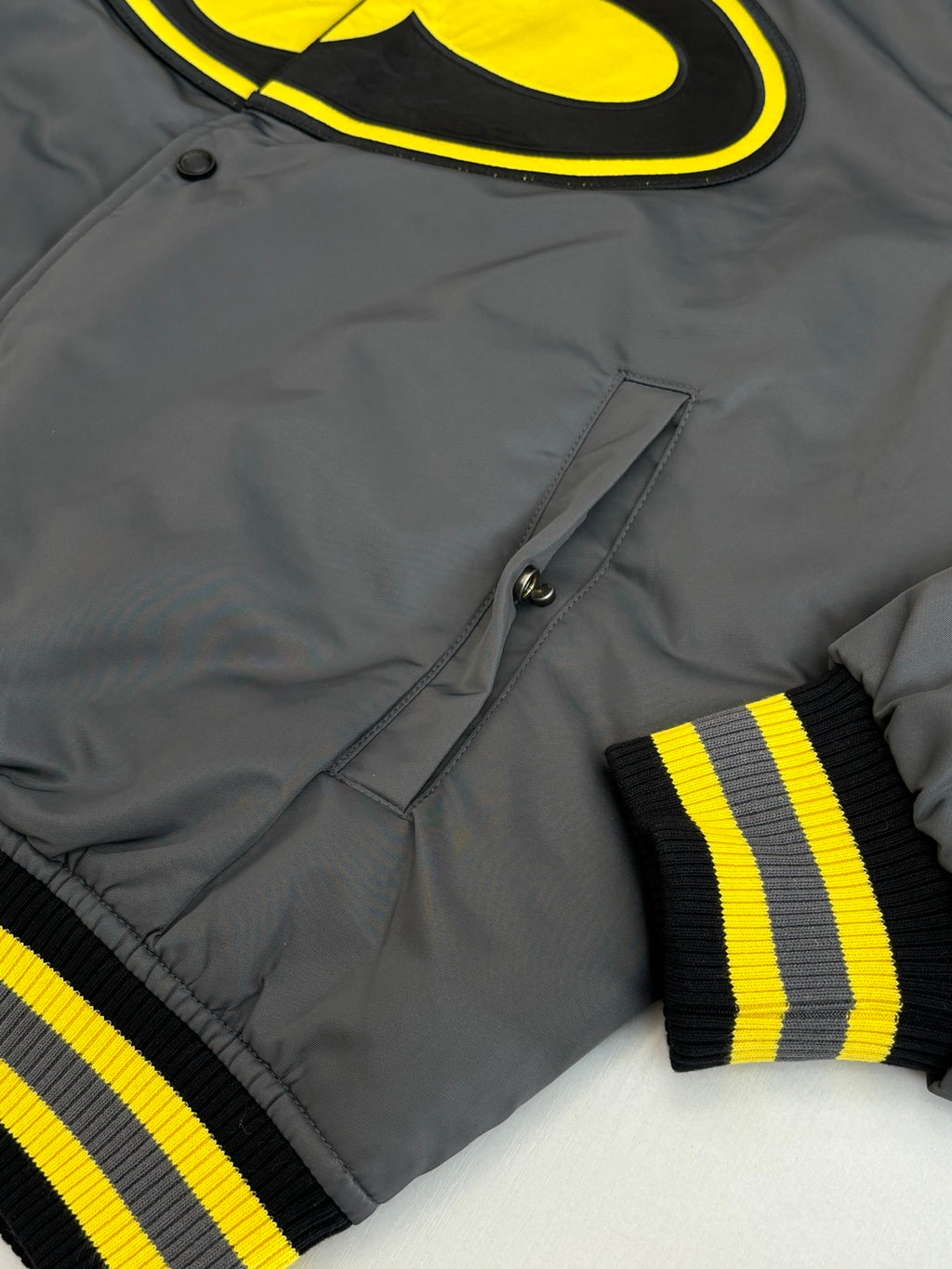 Louis Vuitton bomber jacket front details: snap buttons, yellow stripes on ribbed cuffs