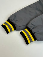 Long jacket cuffs with black and yellow striped ribbed trim