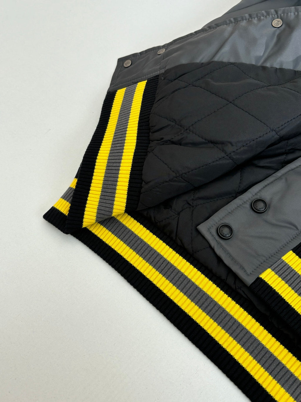 Louis Vuitton bomber jacket sleeve and ribbed striped trim in dark gray with yellow stripes