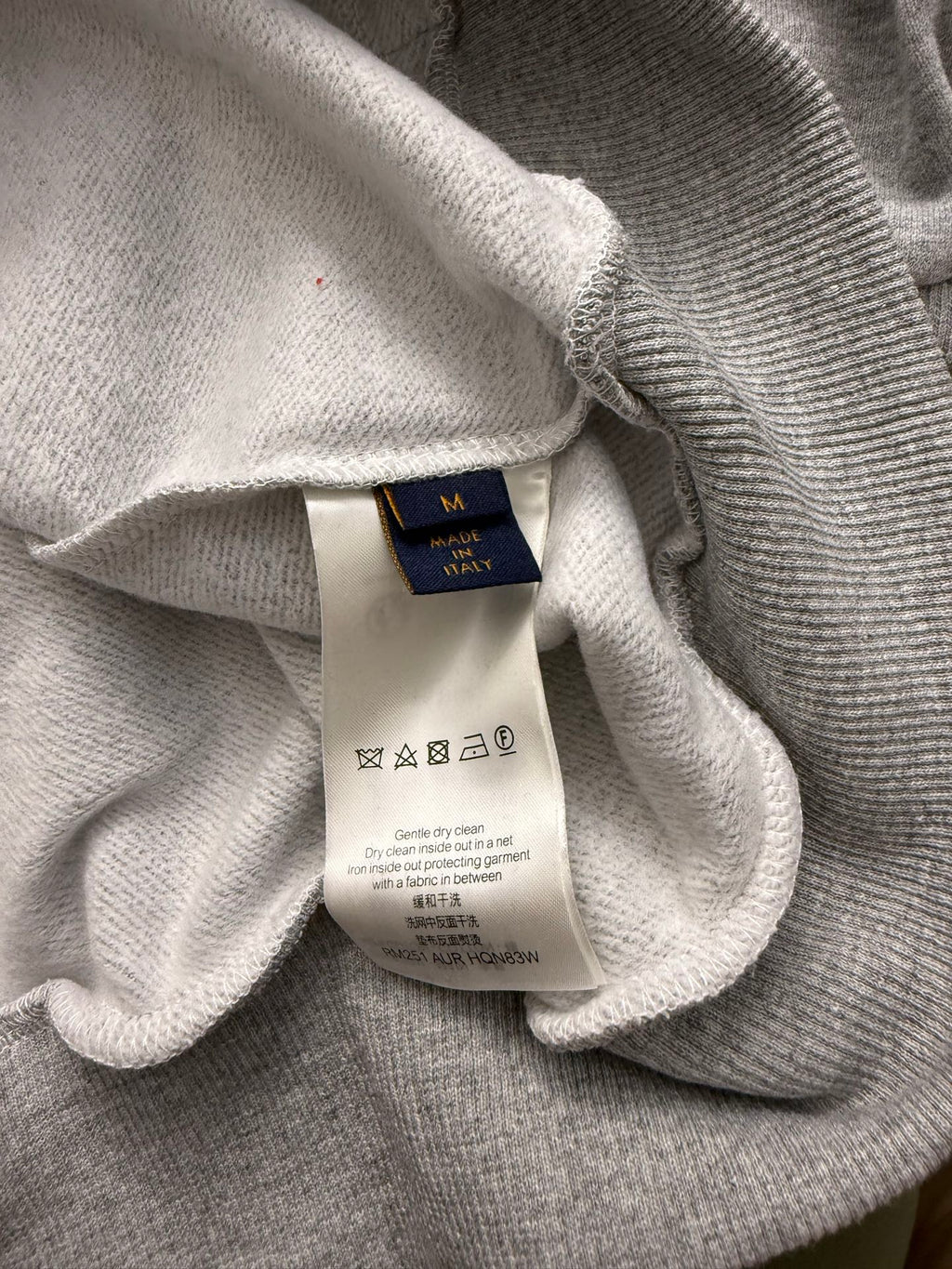 Gray hoodie neckline with size and care label