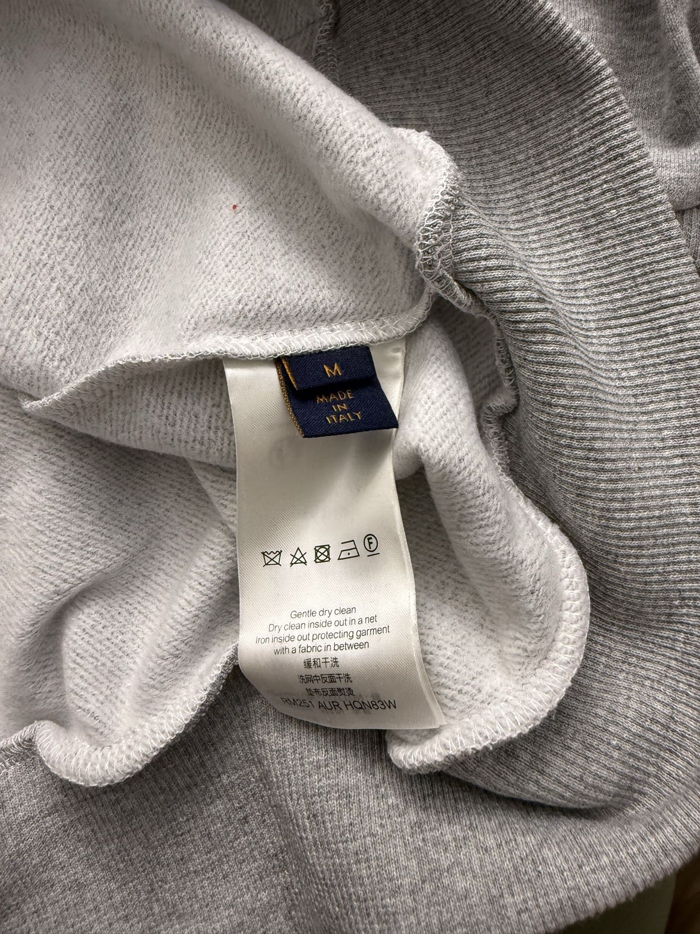 Gray hoodie neckline with size and care label