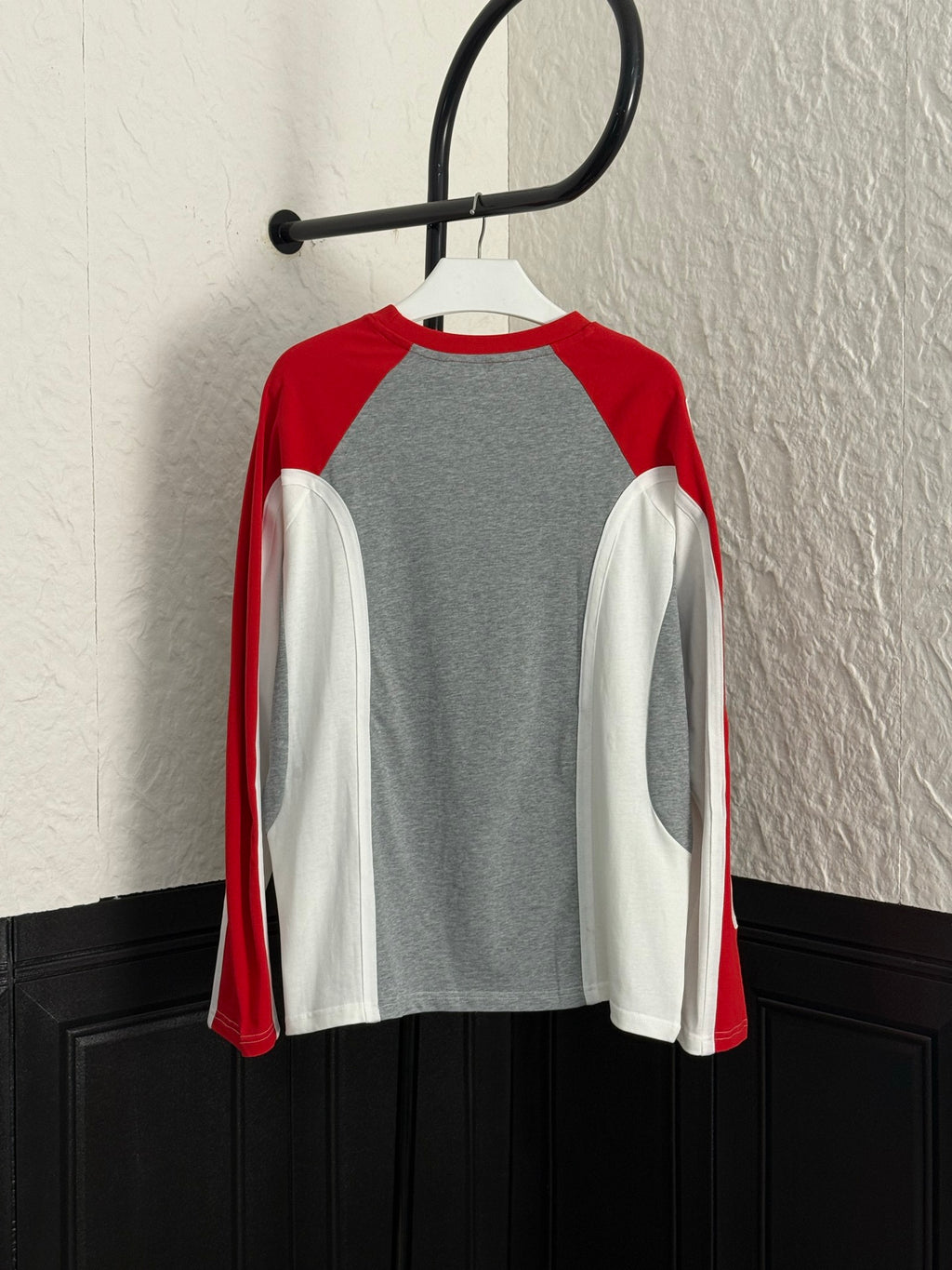 Long-sleeve raglan shirt on hanger: gray center with red and white sleeves, LV logo