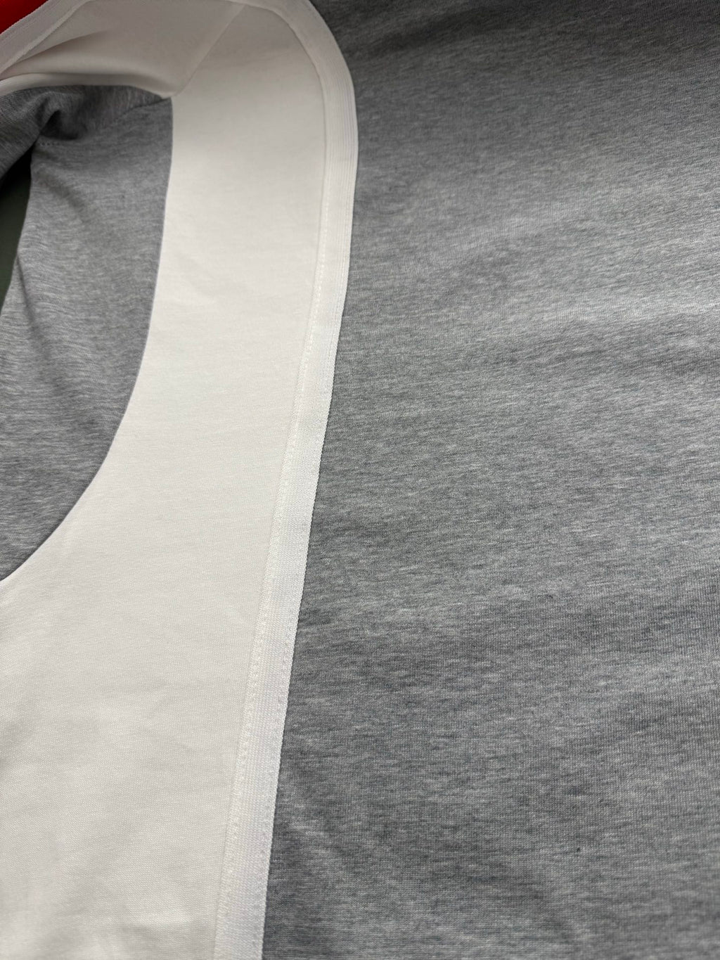 White sleeve panel on a long-sleeve raglan shirt