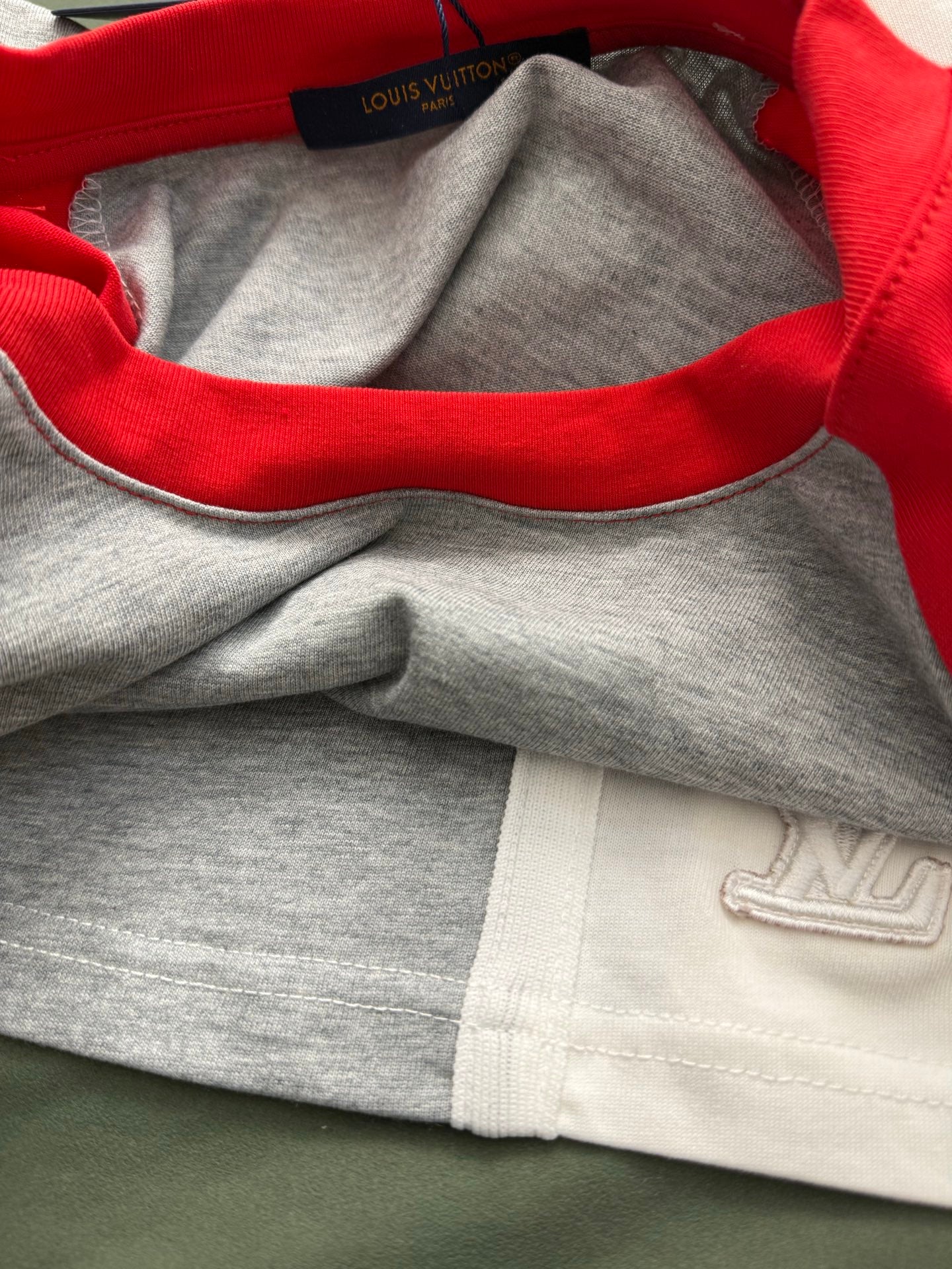 Raglan shirt neckline and sleeve cuffs, red collar and gray fabric with LV logo