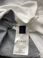 Clothing care label inside collar with washing icons and size information