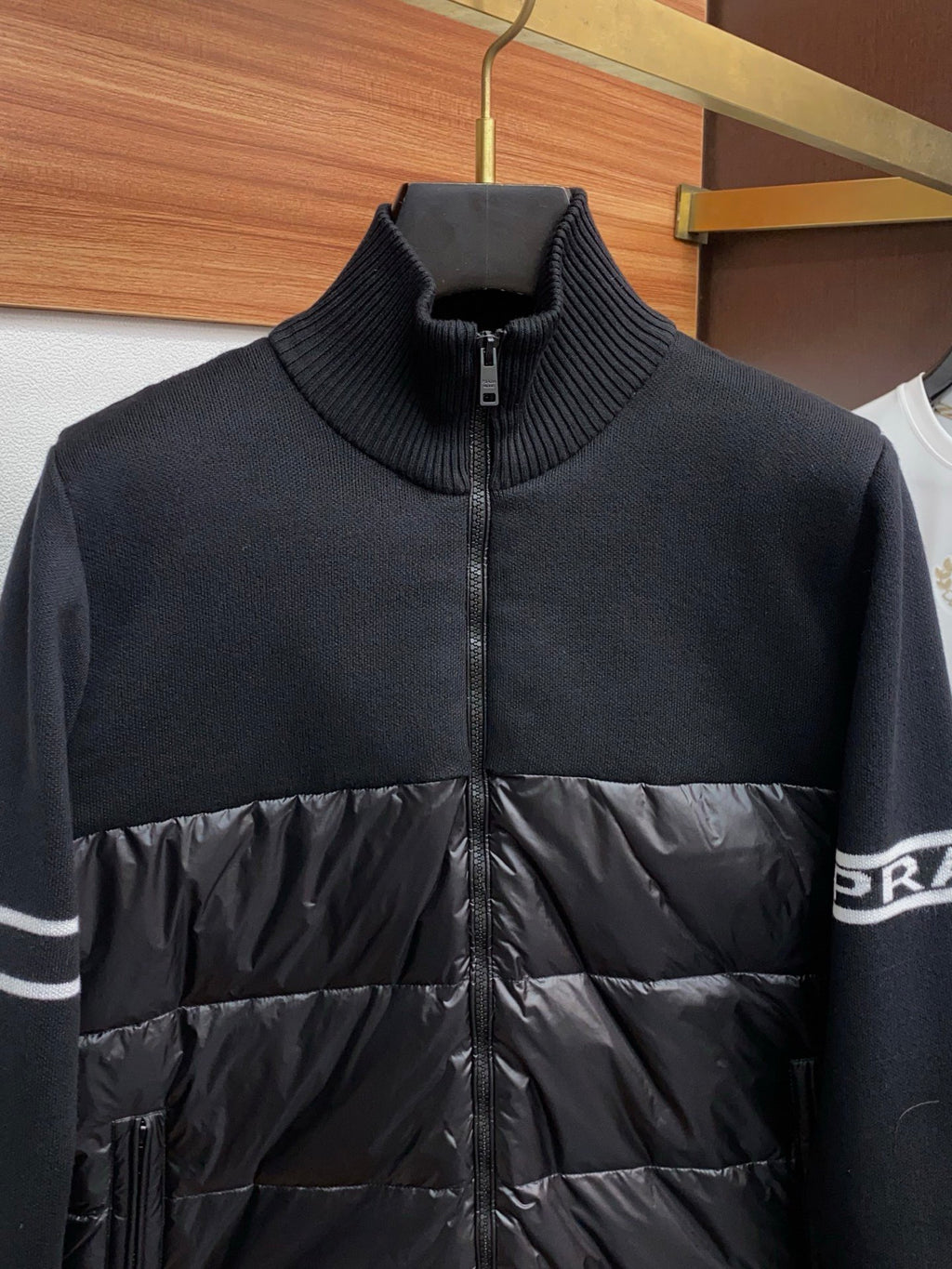 Moncler zip puffer jacket with navy ribbed collar and black quilted front panel