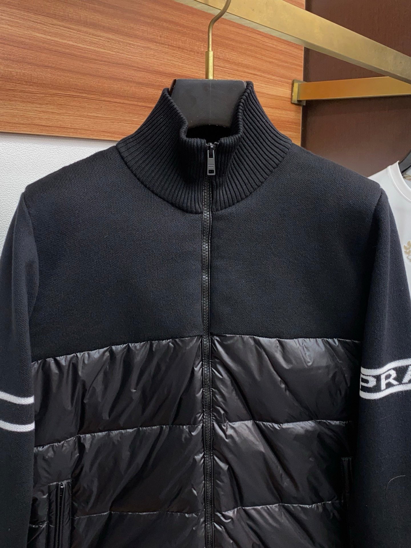 Moncler zip puffer jacket with navy ribbed collar and black quilted front panel