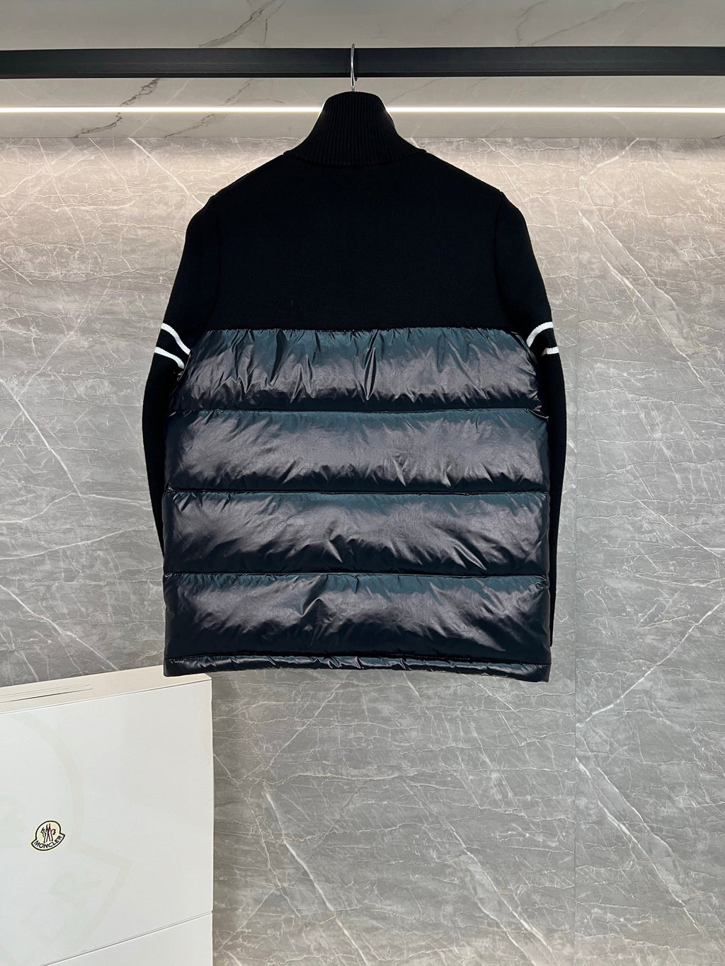 Moncler puffer jacket back view with horizontal quilting and striped sleeve detail