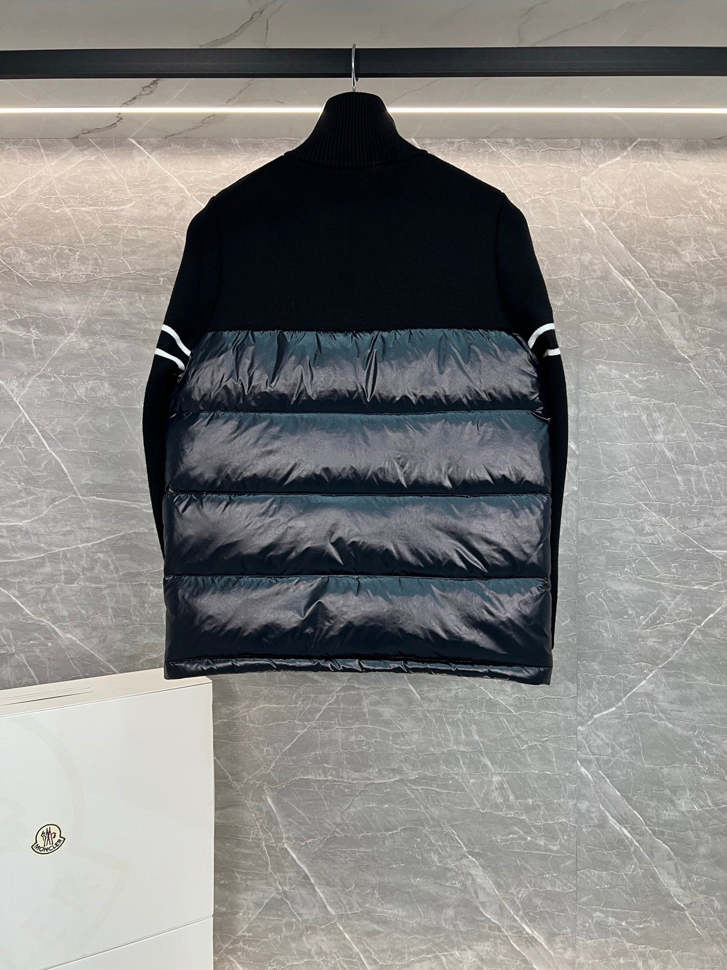 Moncler puffer jacket back view with horizontal quilting and striped sleeve detail