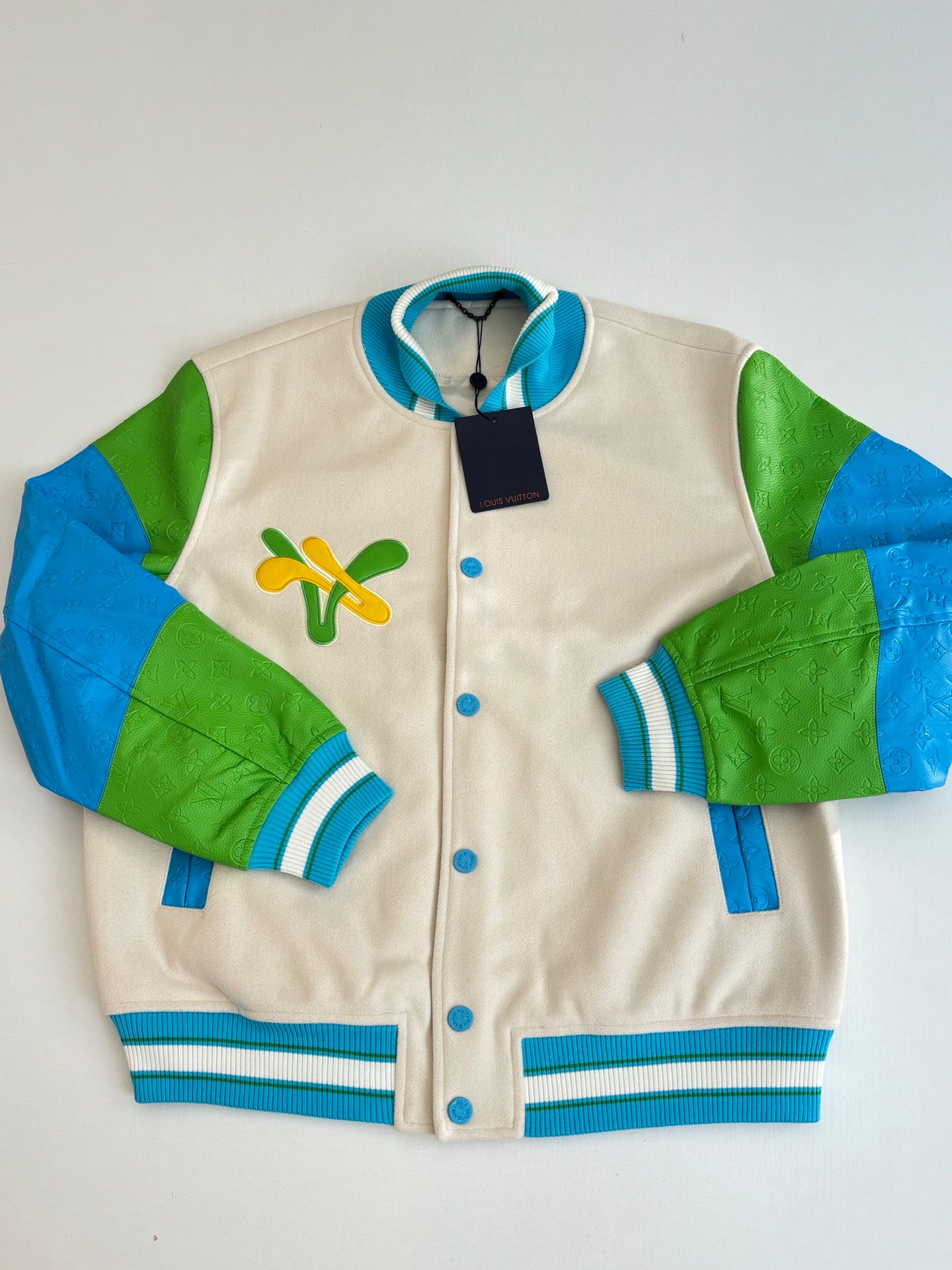 Louis Vuitton button-up jacket, front view, cream body with green and blue sleeve panels
