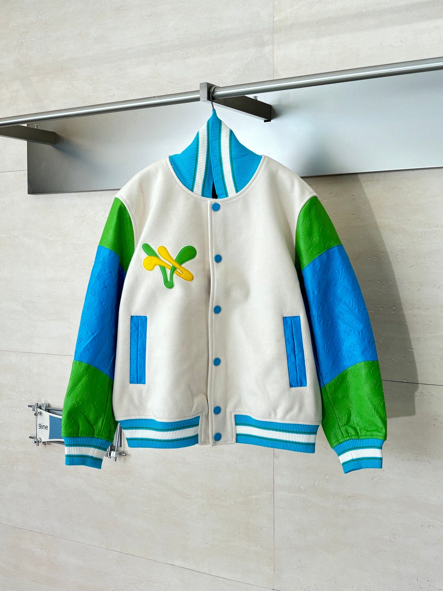 Louis Vuitton button-up jacket in cream with green/blue sleeves and blue striped ribbing