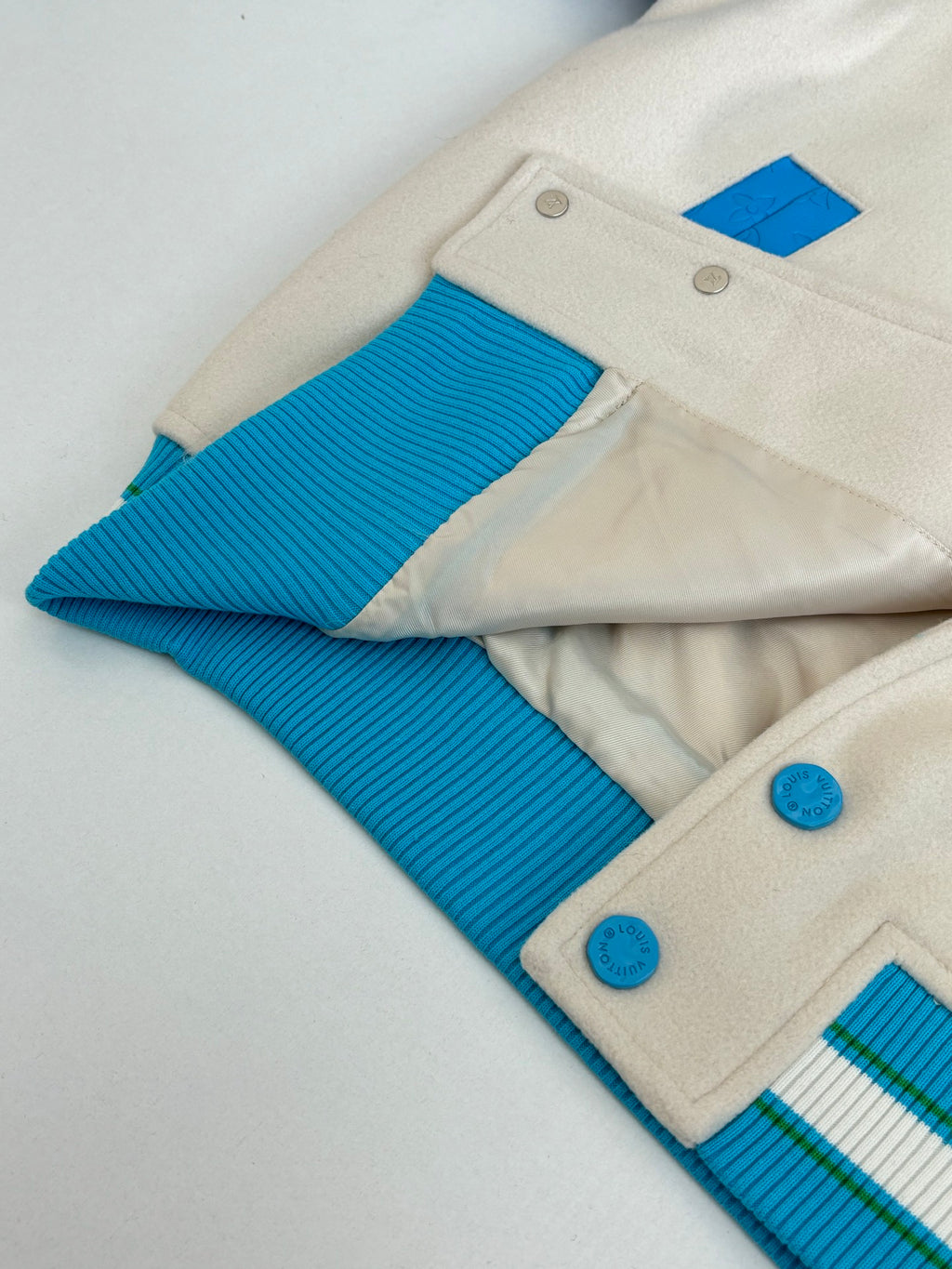 Louis Vuitton jacket interior hem and snap buttons with blue ribbed sleeve cuffs