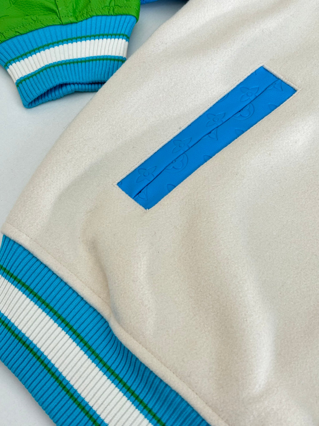 Louis Vuitton button-up jacket details: cream fabric with blue striped ribbed cuff