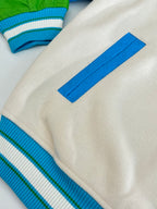 Louis Vuitton button-up jacket details: cream fabric with blue striped ribbed cuff
