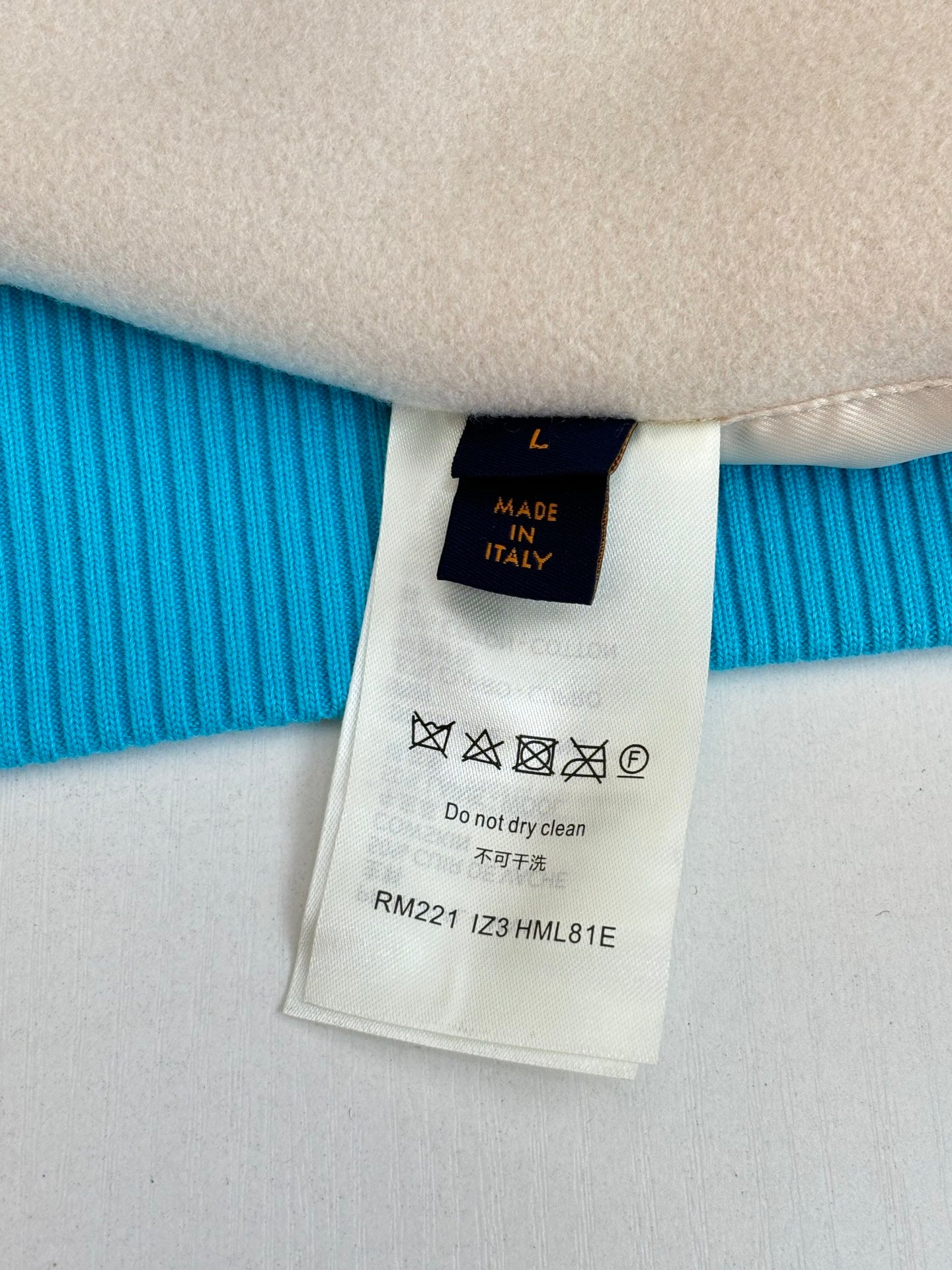 Care label on Louis Vuitton long-sleeve knit sweater, size L, made in Italy