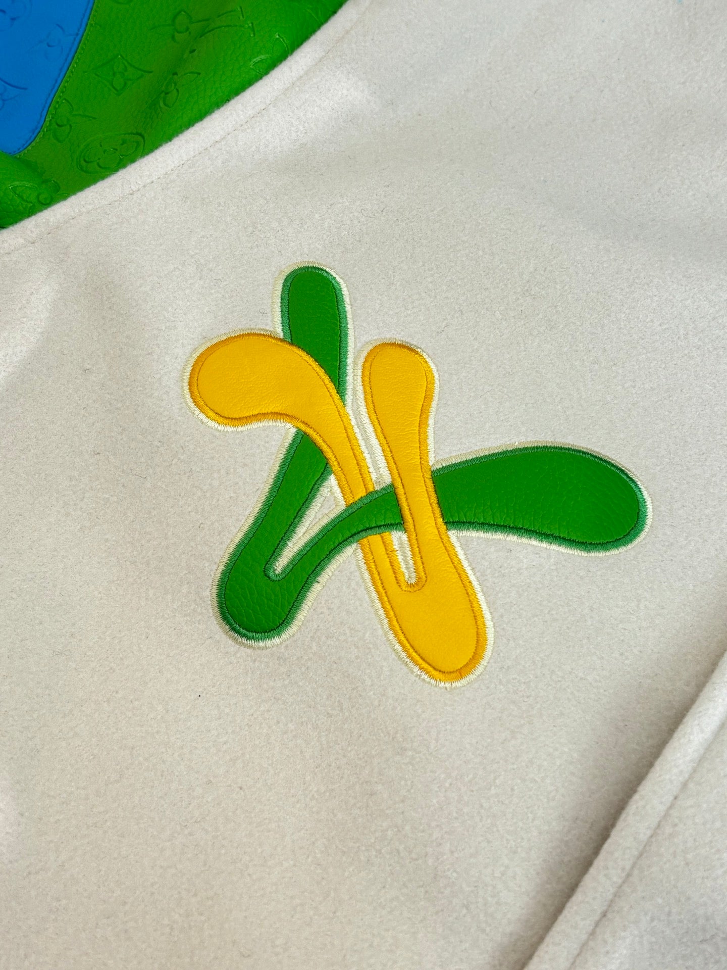 Louis Vuitton applique patch on cream fabric: green and yellow whimsical motif
