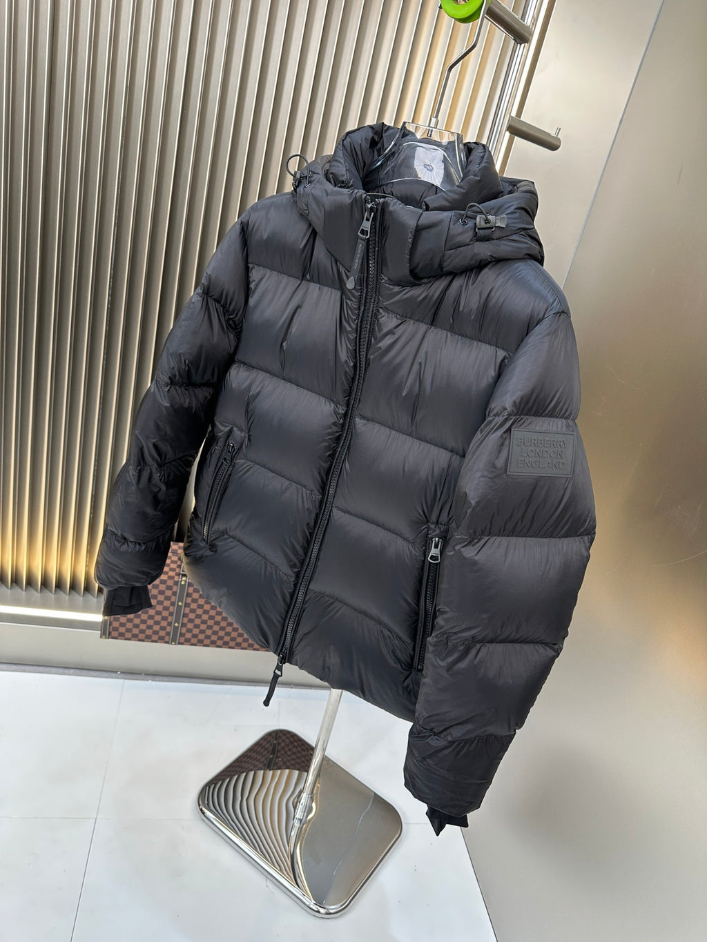 Burberry long padded hooded jacket with front zipper and quilted panels, dark navy