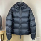 Long hooded puffer jacket, dark color, close-up front with full zipper and hood