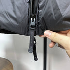 Burberry jacket close-up of front zipper with fabric pull tab, dark navy