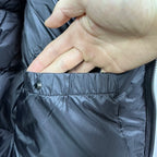 Burberry padded jacket close-up of snap button and front pocket opening, dark navy