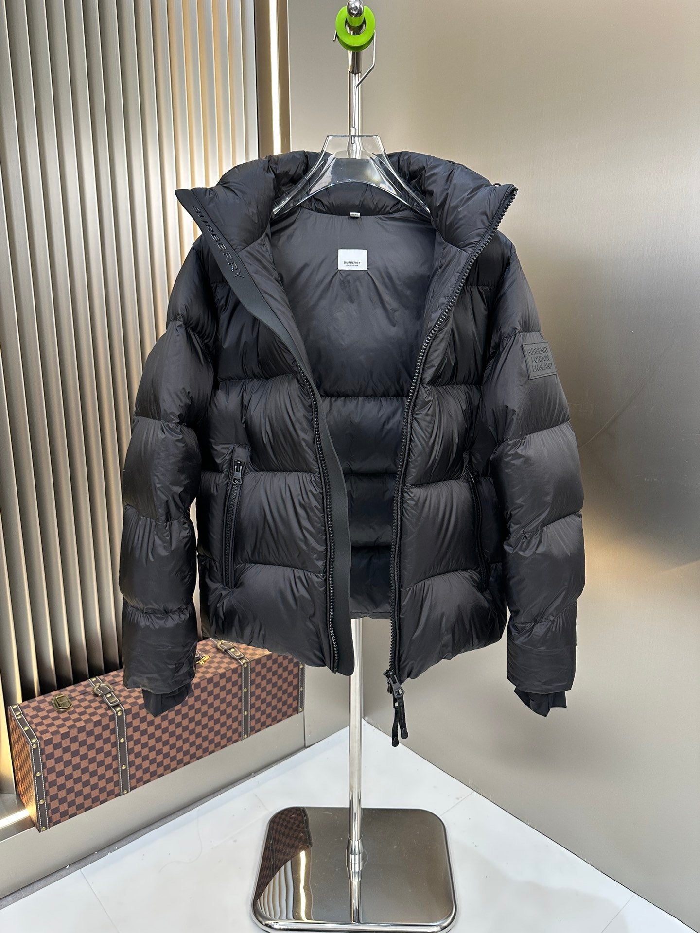 Burberry long padded jacket with hood, front zipper, and structured puffer sleeves, dark navy