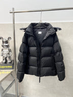 Long hooded puffer jacket, dark color, angled view with quilted panels and hood