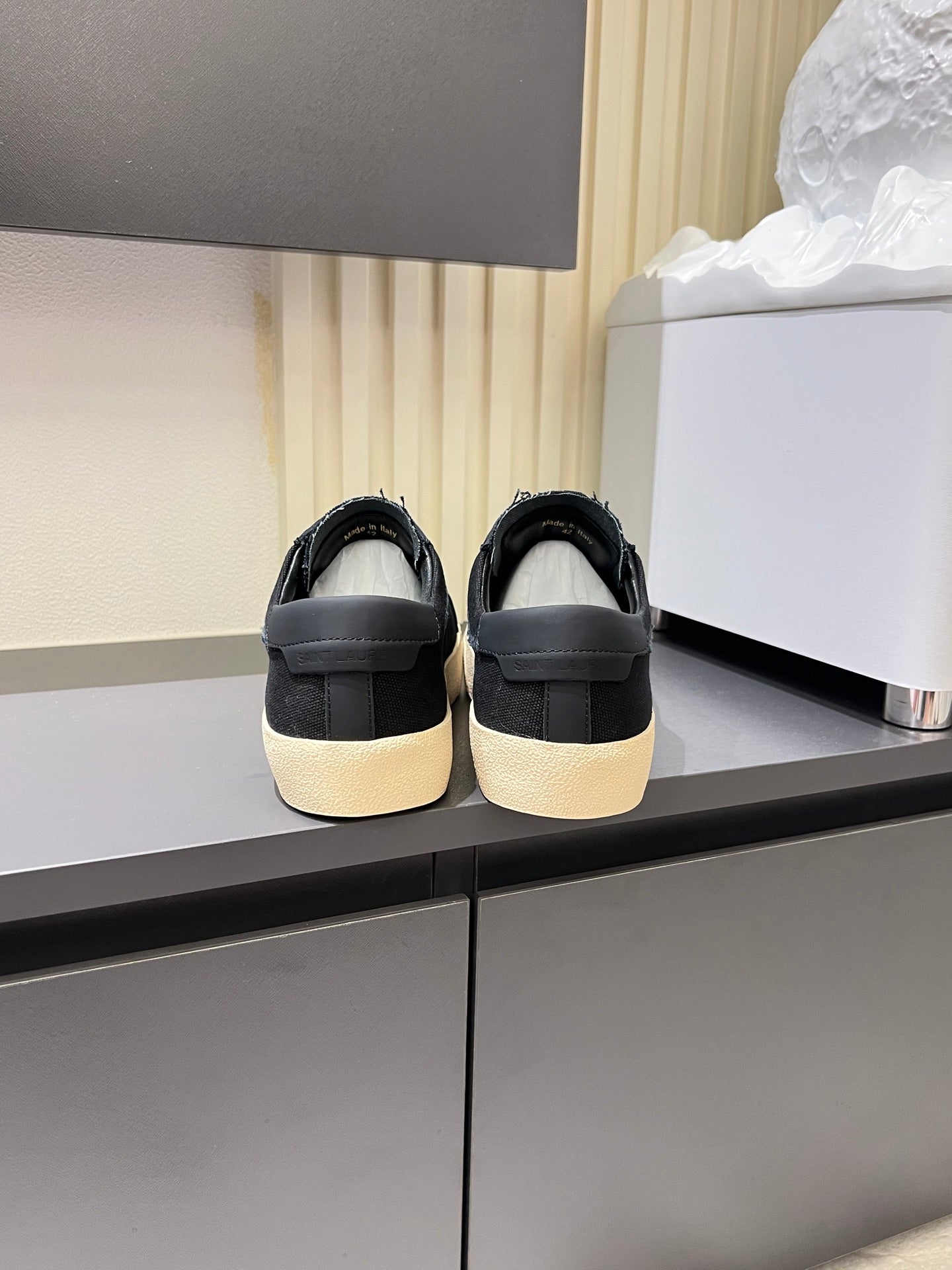Saint Laurent unisex sneakers showing heel backs, dark gray uppers and cream soles