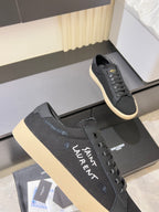 Saint Laurent unisex sneakers close-up with dark gray fabric and lace-up eyelets