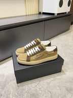 YSL unisex sneakers on box, tan canvas with brown logo patch and white laces