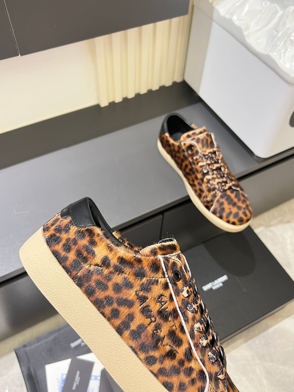 YSL leopard-print lace-up sneakers, front corner view on display box