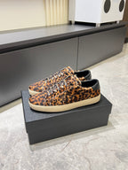 YSL leopard-print lace-up sneakers with white sole, side view on box