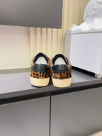 YSL leopard-print sneakers with black heel panels, back view on shelf