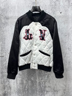 Quilted black-and-white jacket with button front and logo patches