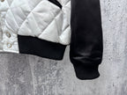 Quilted jacket hem with ribbed cuff and snap buttons on white panel