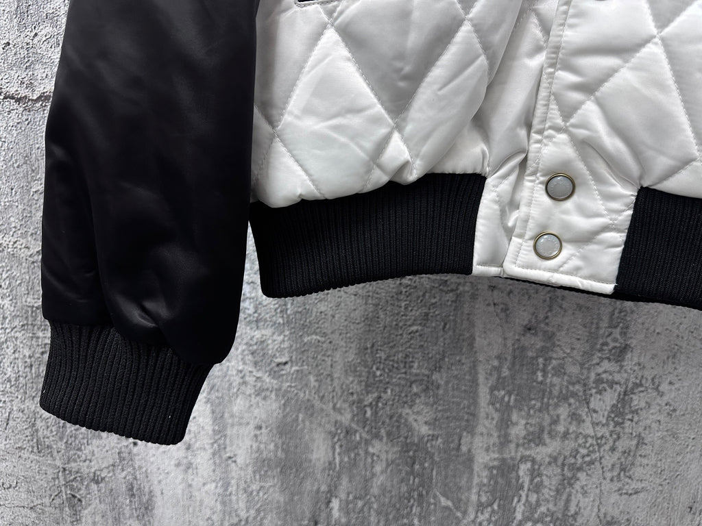 Quilted jacket sleeve with ribbed cuff and snap-detailed white front panel