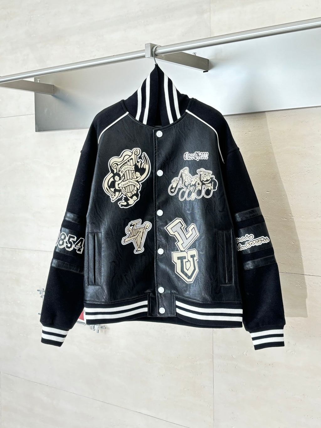 Louis Vuitton long jacket, black with striped ribbed collar and cream crest patches