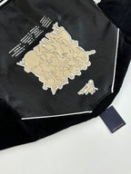 Louis Vuitton long jacket back close-up, black with cream graphic illustration and small text