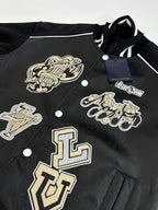 Louis Vuitton long jacket close-up, black with cream logo emblems and snap buttons