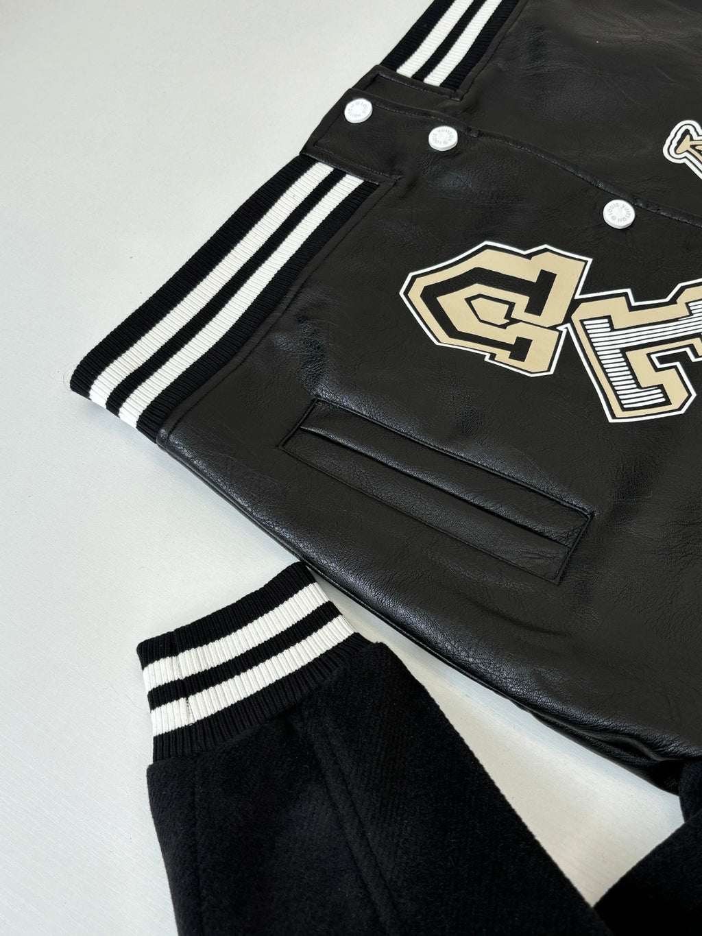 Louis Vuitton long jacket, black with cream logo patch, welt pocket and striped trim