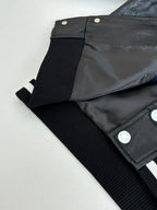Louis Vuitton long jacket close-up, black collar and striped ribbed trim with snap buttons